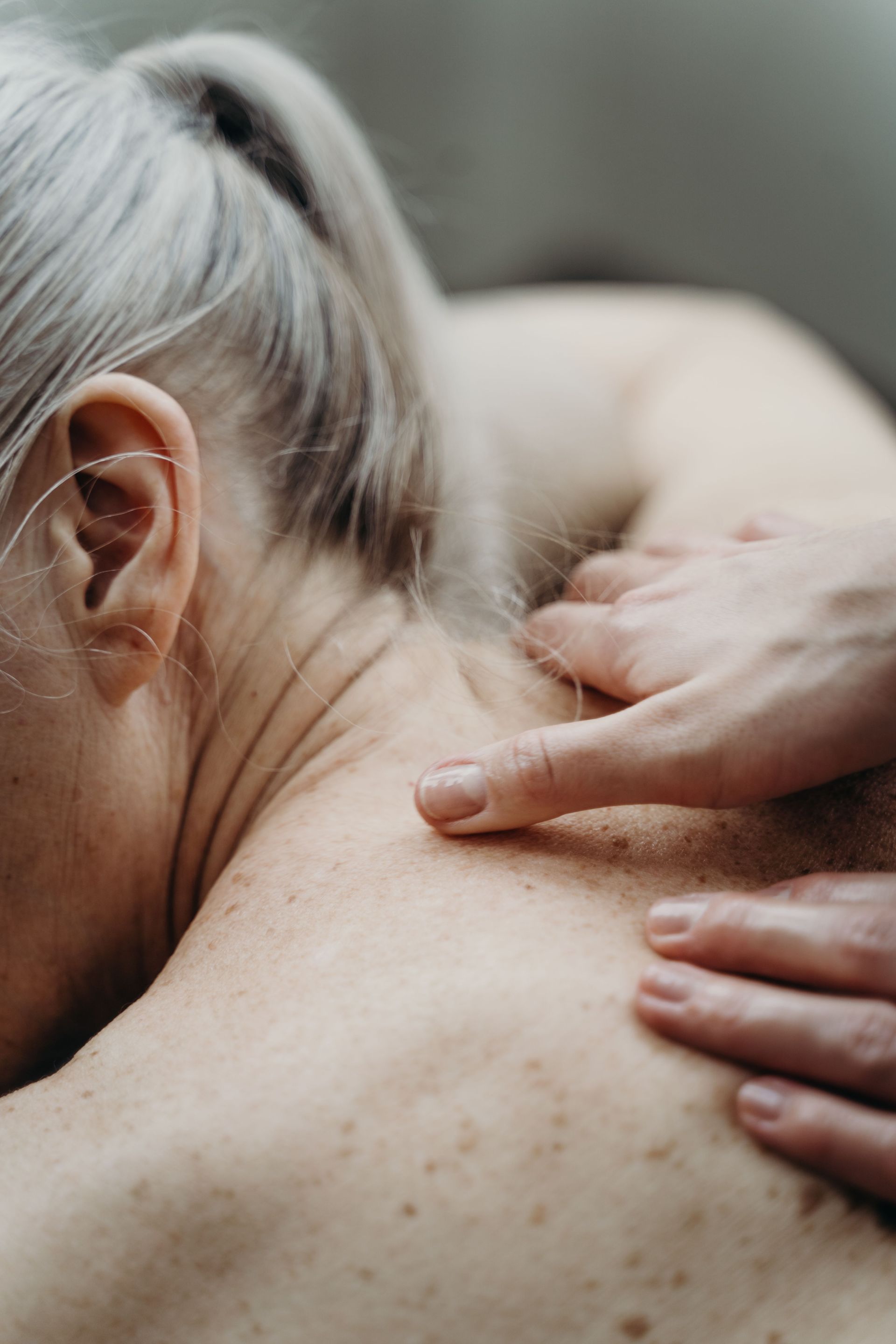 Close-up of a shoulder massage showing gentle hand pressure for relaxation.